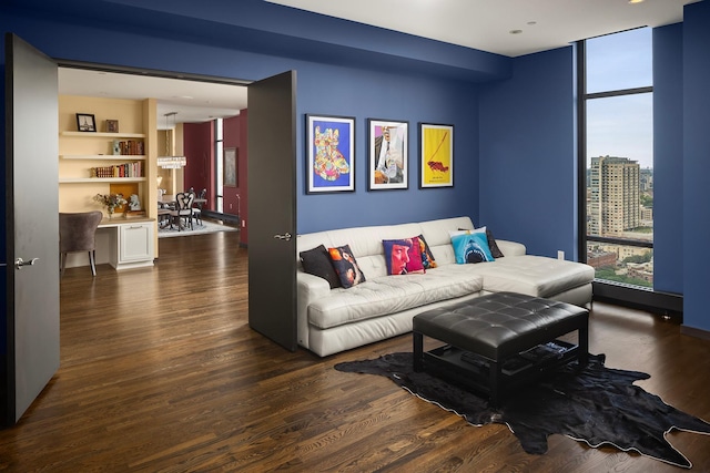 living room featuring a wall of windows and dark wood-type flooring