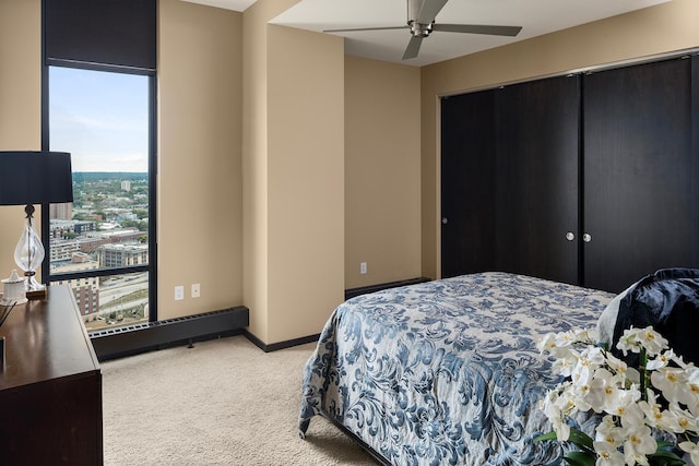 bedroom featuring multiple windows, ceiling fan, and carpet floors