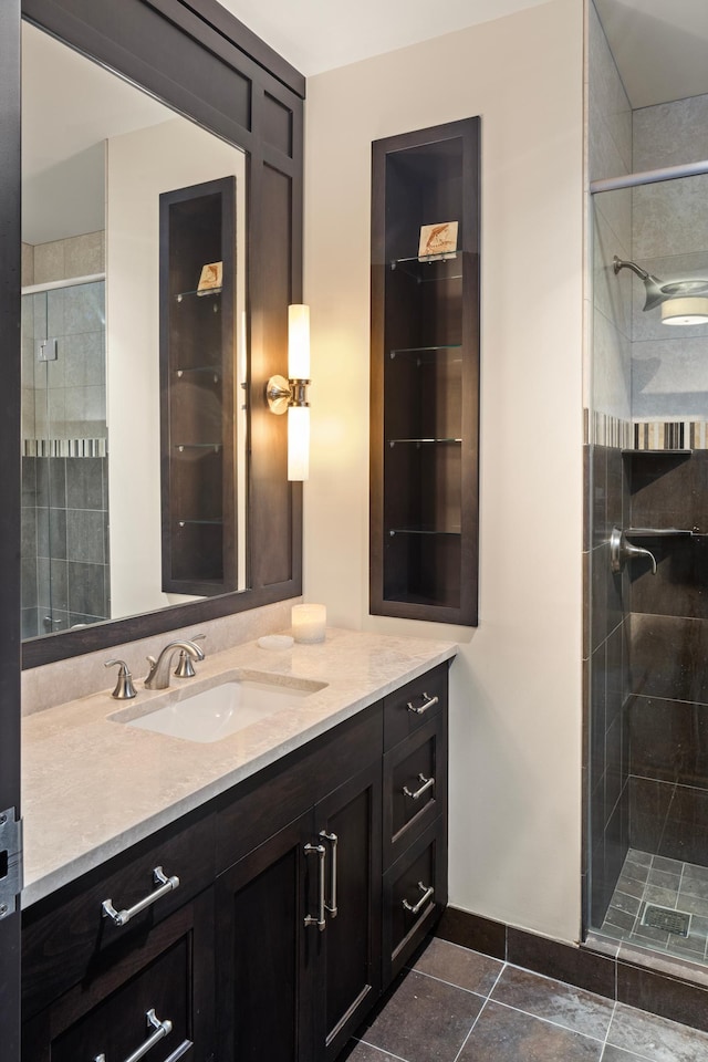 bathroom featuring walk in shower, vanity, and tile patterned floors