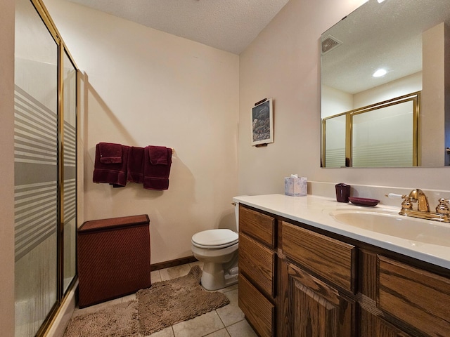 bathroom featuring tile patterned floors, walk in shower, vanity, a textured ceiling, and toilet