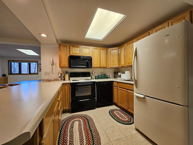 kitchen with kitchen peninsula, light tile patterned flooring, and black appliances