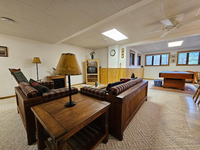 living room featuring a paneled ceiling, ceiling fan, wood walls, and billiards