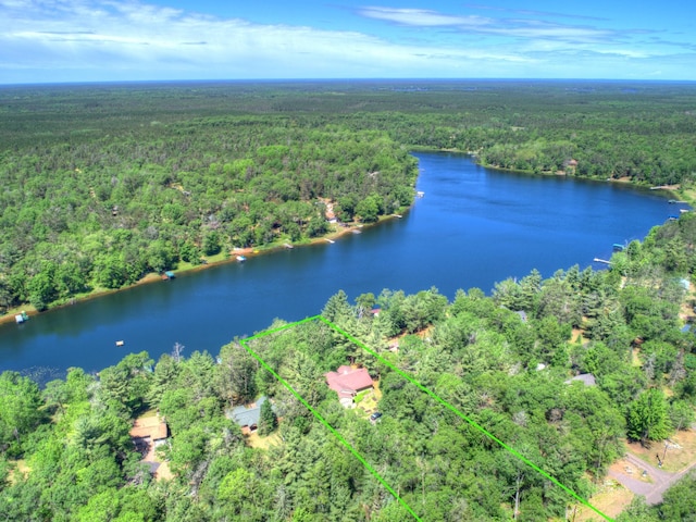 view of property location featuring a forest, property boundaries highlighted, and a large body of water