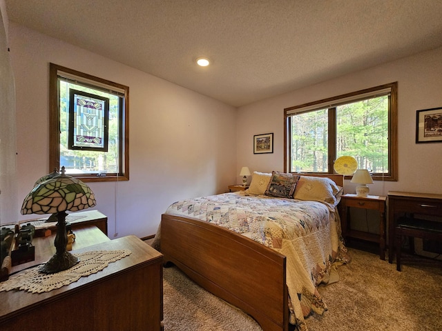 carpeted bedroom featuring a textured ceiling and recessed lighting