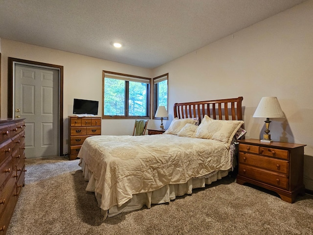 carpeted bedroom featuring a textured ceiling and recessed lighting