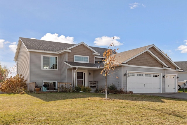 view of front of property with driveway, a front lawn, roof with shingles, and an attached garage