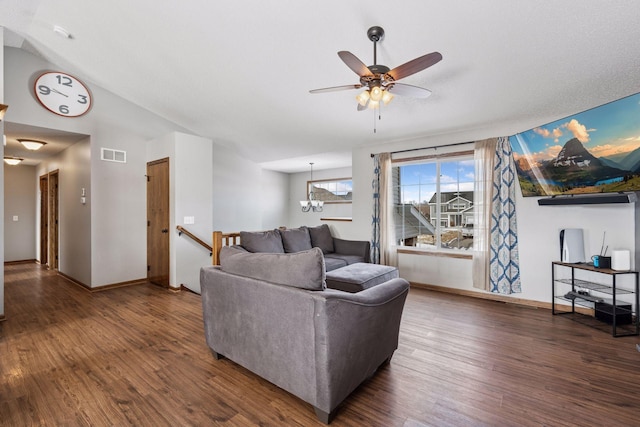 living area featuring baseboards, visible vents, wood finished floors, and ceiling fan with notable chandelier