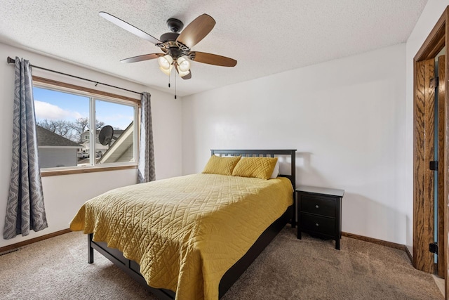 bedroom with carpet flooring, a textured ceiling, and baseboards