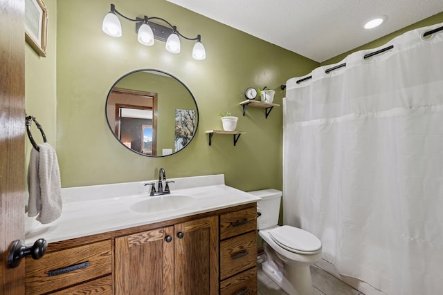 full bathroom featuring curtained shower, toilet, vanity, a textured ceiling, and tile patterned flooring