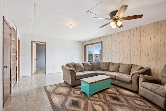 living area featuring concrete floors and a ceiling fan