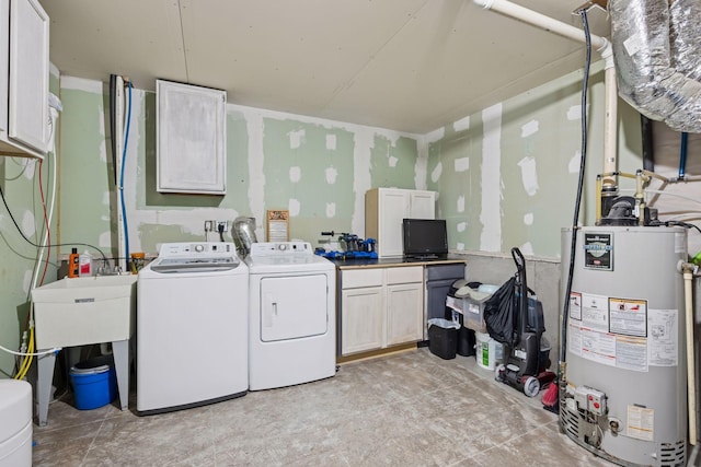 laundry room with cabinet space, washing machine and dryer, and water heater