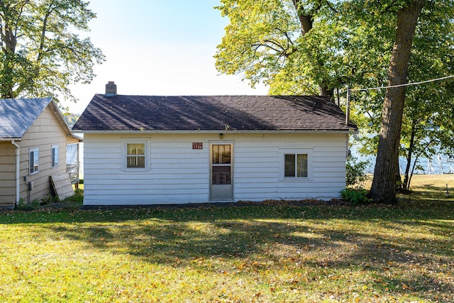 rear view of house with a yard