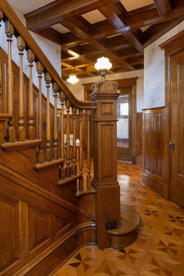 interior space featuring wooden walls, beamed ceiling, coffered ceiling, and parquet flooring