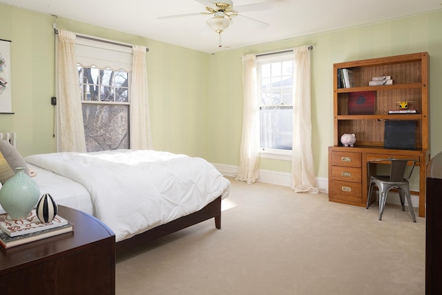 bedroom with ceiling fan and light carpet