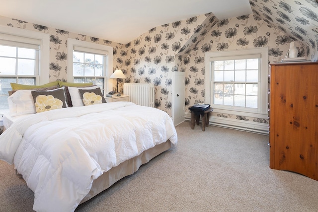 bedroom featuring radiator, carpet floors, and lofted ceiling