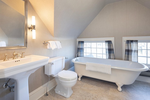 bathroom featuring a tub and vaulted ceiling