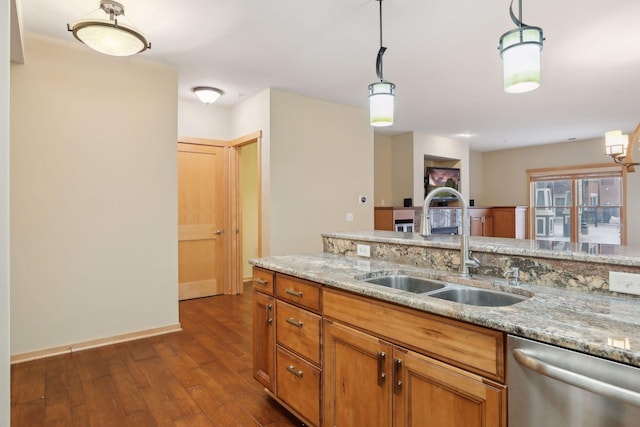 kitchen featuring dark hardwood / wood-style flooring, dishwasher, sink, light stone countertops, and pendant lighting