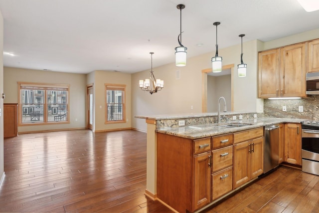 kitchen featuring kitchen peninsula, stainless steel appliances, and dark hardwood / wood-style flooring