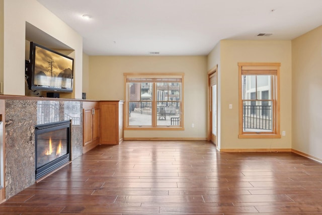 unfurnished living room with dark wood-type flooring