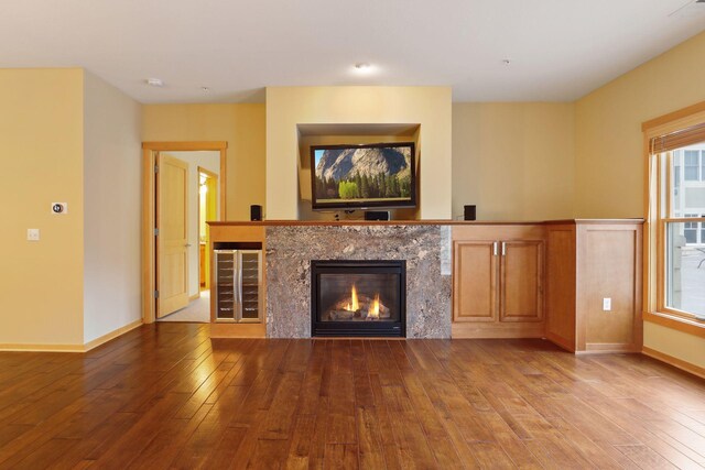 unfurnished living room with wood-type flooring and a premium fireplace