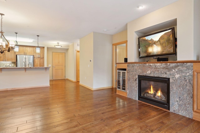 unfurnished living room with a fireplace and wood-type flooring