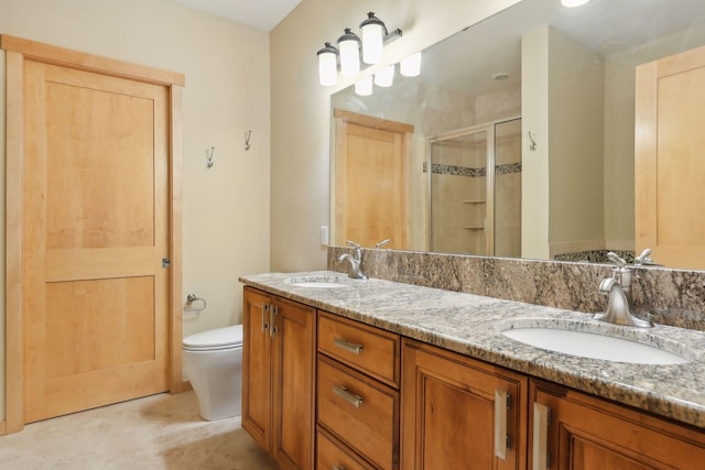 bathroom featuring toilet, vanity, and walk in shower