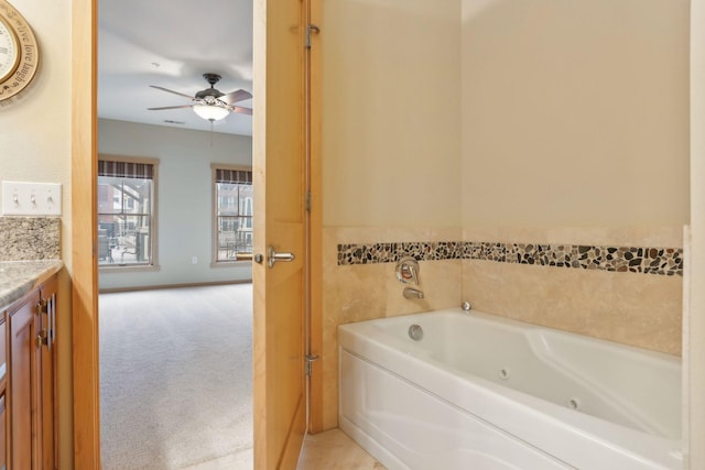 bathroom featuring a bathtub, vanity, and ceiling fan