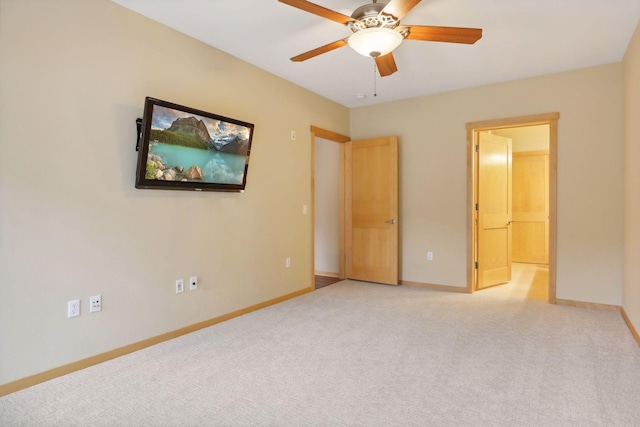 unfurnished bedroom featuring ceiling fan and light carpet