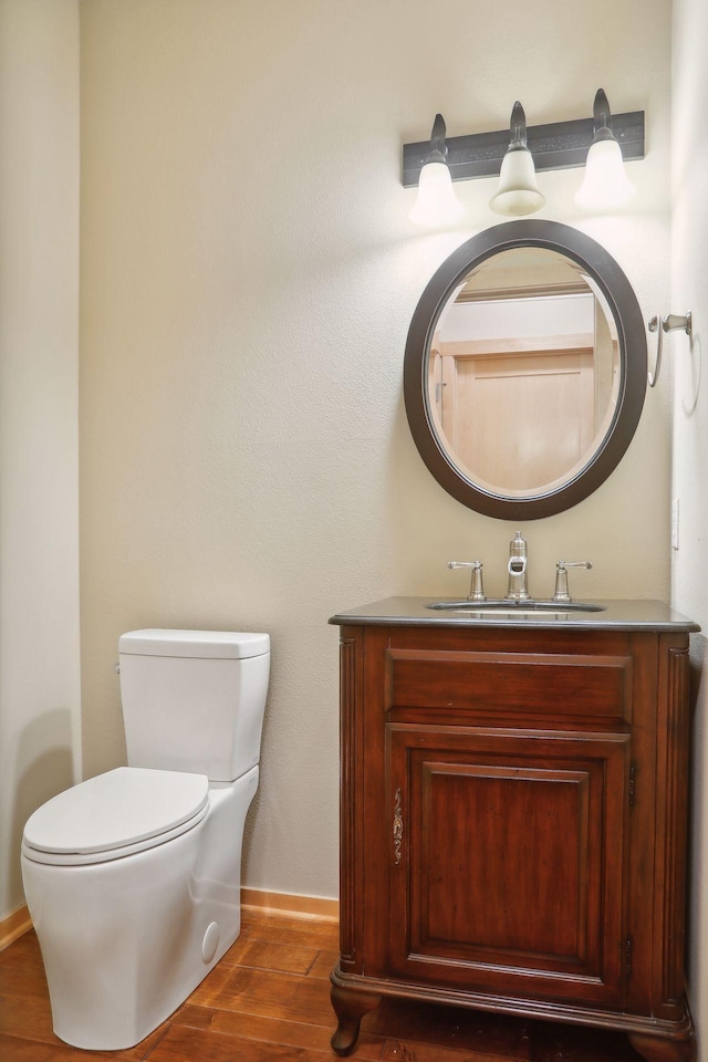 bathroom featuring hardwood / wood-style flooring, vanity, and toilet