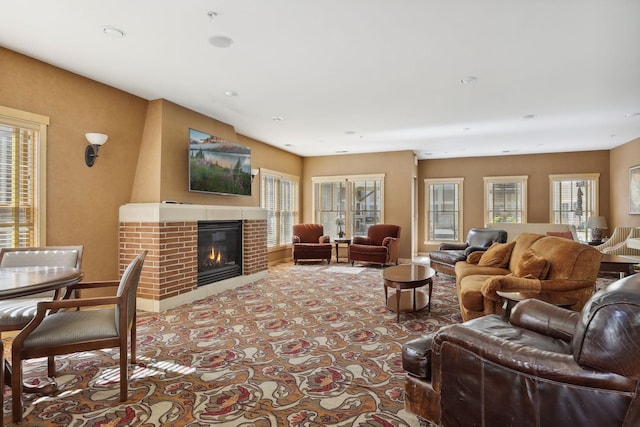 living room featuring a wealth of natural light and a fireplace