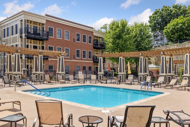 view of swimming pool featuring a patio and a pergola