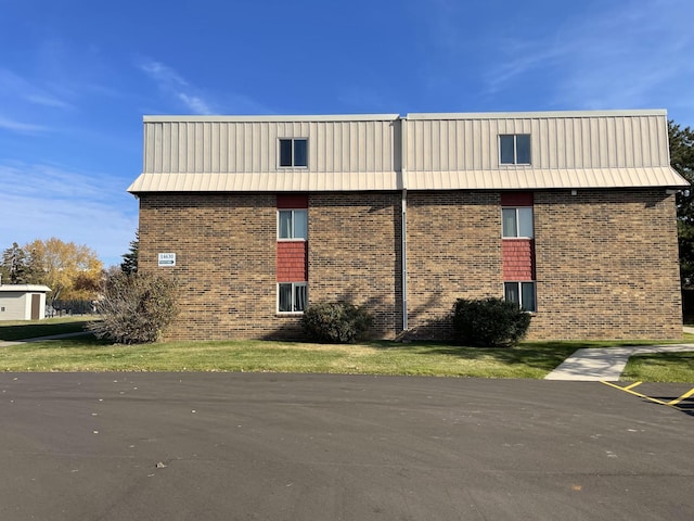 view of side of home featuring a yard