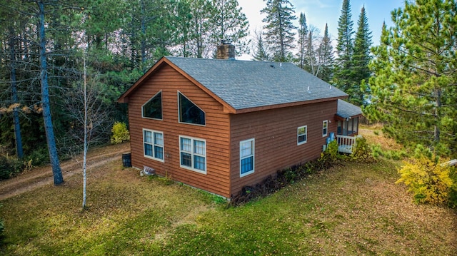 back of house with a lawn and central AC