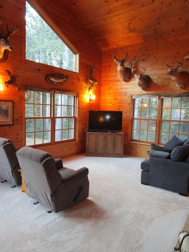 carpeted living room with wooden walls, wood ceiling, and high vaulted ceiling