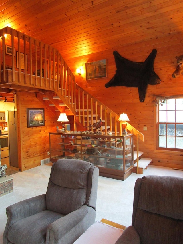 carpeted living room featuring wood walls, wooden ceiling, and lofted ceiling