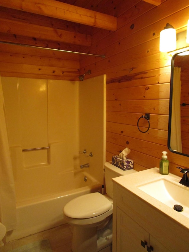 full bathroom featuring beam ceiling, wood walls, toilet, shower / washtub combination, and vanity