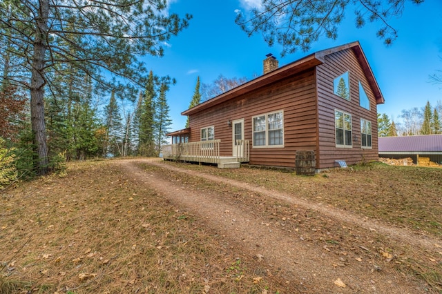 view of side of home featuring a wooden deck