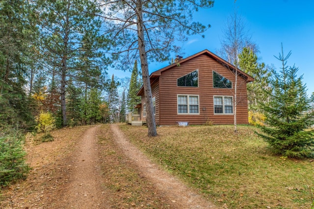 view of side of property with a lawn