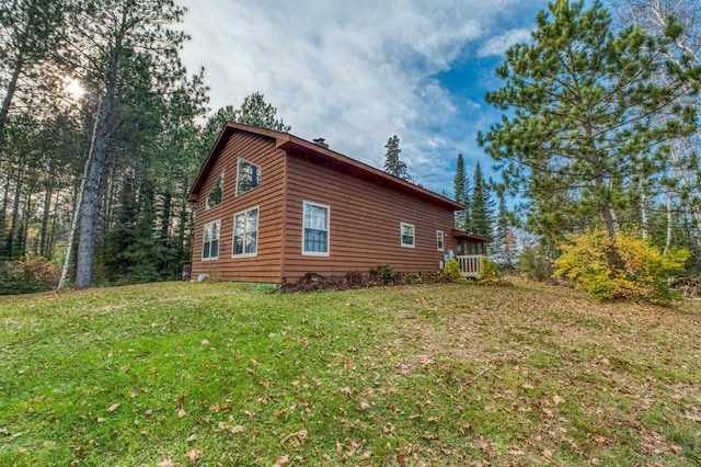 view of home's exterior with central AC unit and a lawn