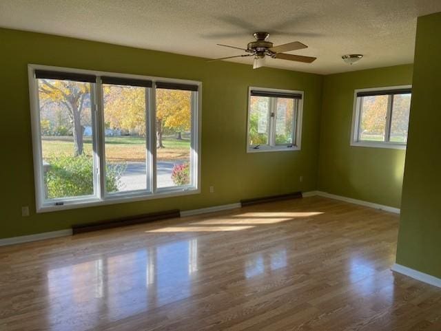 spare room featuring hardwood / wood-style floors, a textured ceiling, and ceiling fan