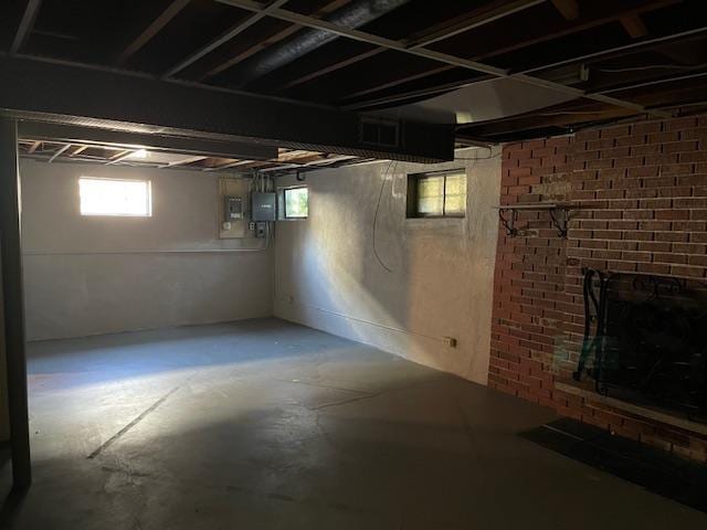 basement featuring electric panel and a fireplace