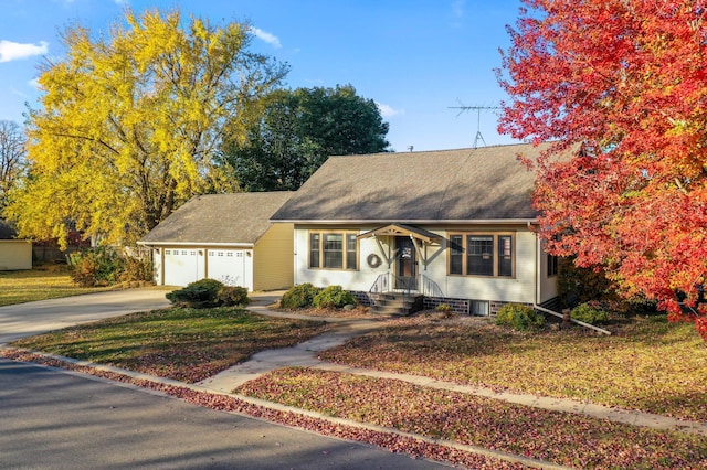 view of front of house featuring a garage and a front lawn