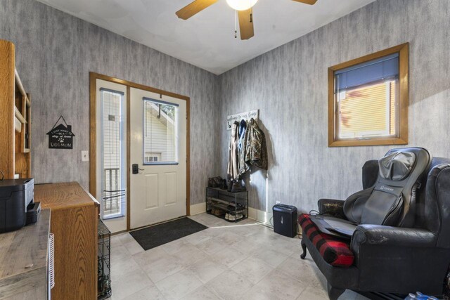 foyer featuring a healthy amount of sunlight and ceiling fan