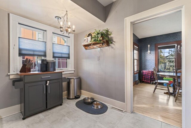 interior space with an inviting chandelier and light hardwood / wood-style floors