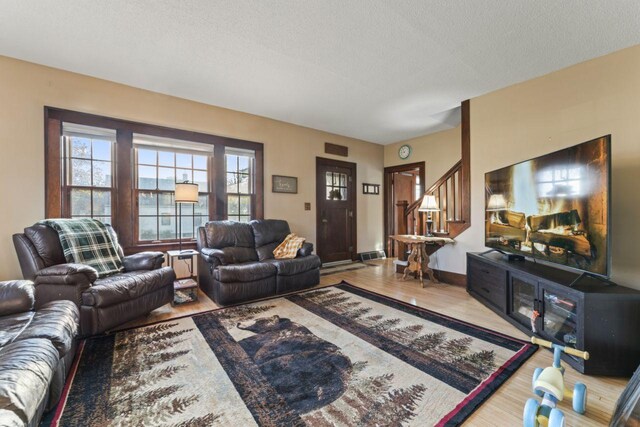 living room with hardwood / wood-style floors and a textured ceiling