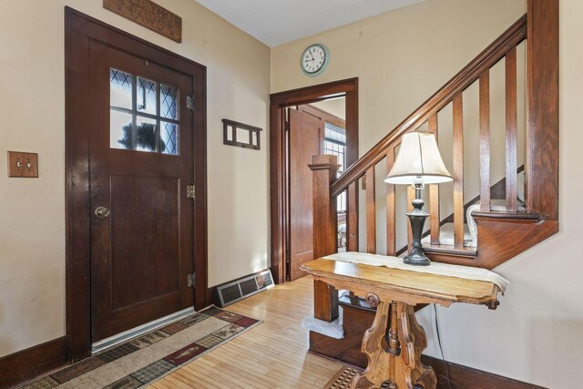 entrance foyer with wood-type flooring and a textured ceiling