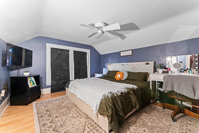 bedroom featuring hardwood / wood-style flooring, lofted ceiling, and ceiling fan