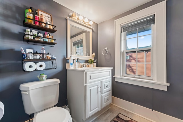 bathroom featuring vanity, tile patterned floors, and toilet