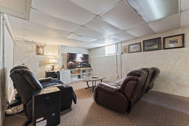 living room with carpet flooring and a drop ceiling