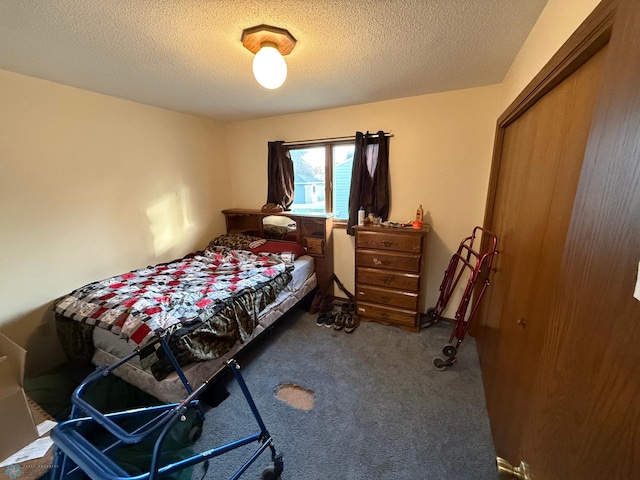 bedroom featuring a textured ceiling and dark colored carpet